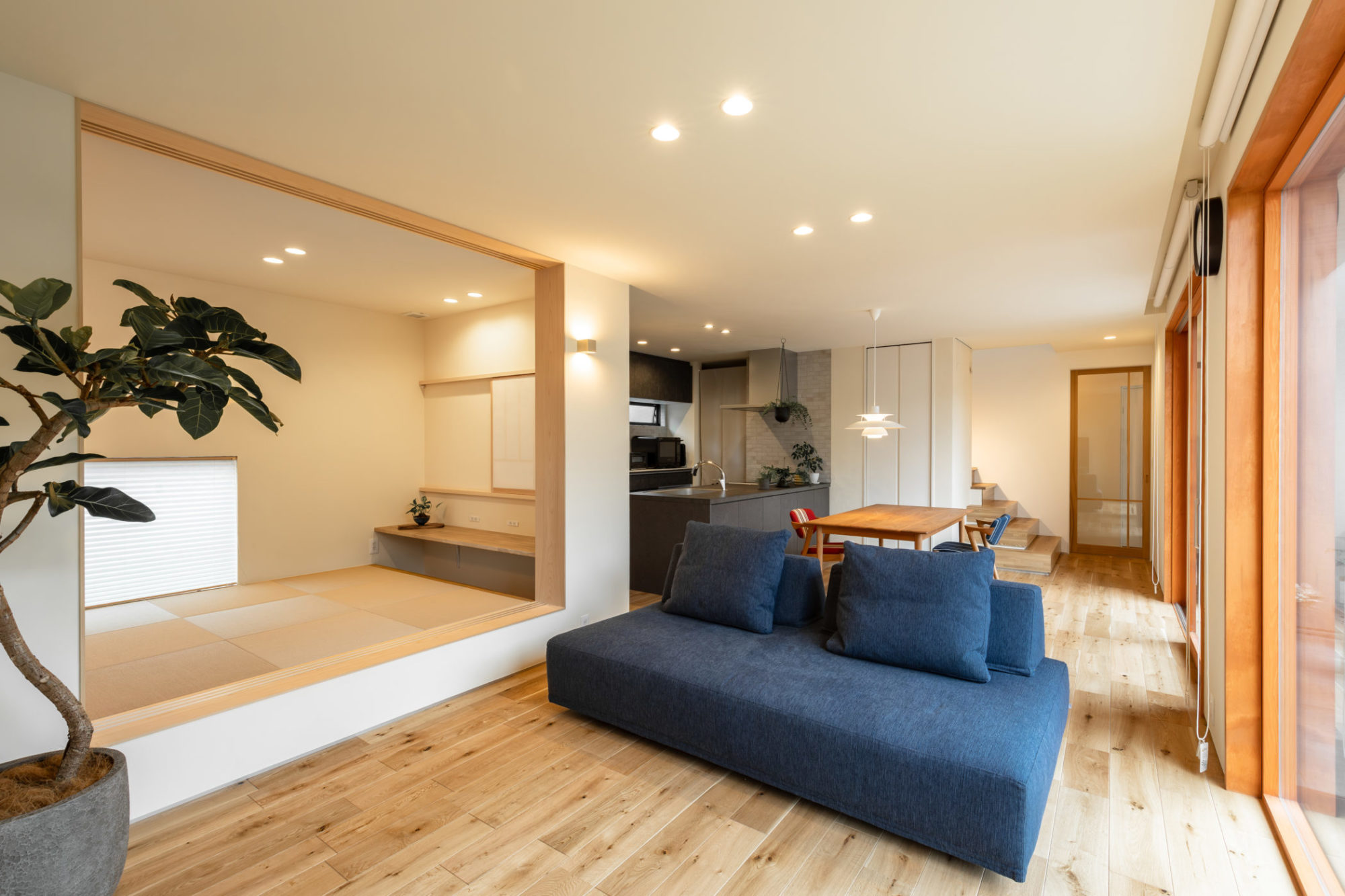 塗り壁と木製サッシと無垢床のLDKと、隣接する小上がり和室の施工写真